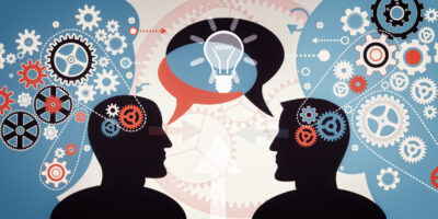Silhouettes of two people with overlapping speech bubbles between them